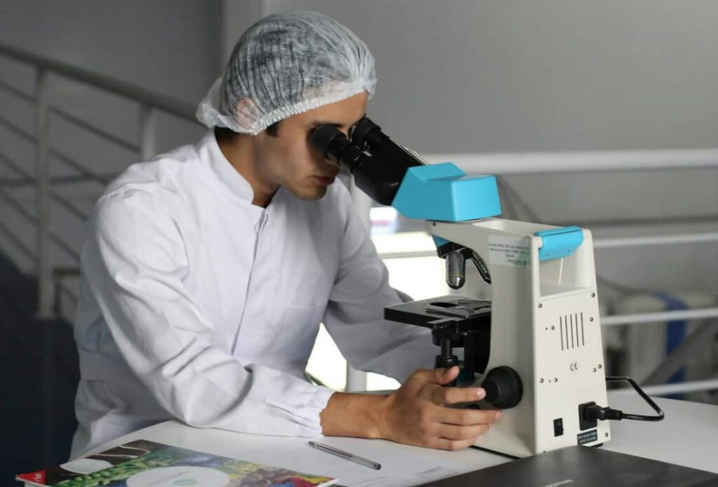 Scientist using a microscope in a lab