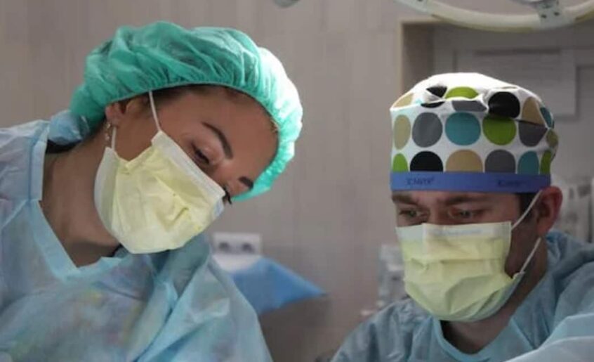 Surgeons in scrubs focused on surgery