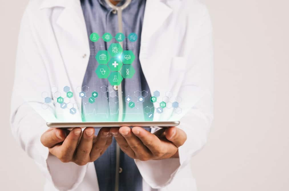 A doctor holds a tablet displaying floating healthcare-related graphics