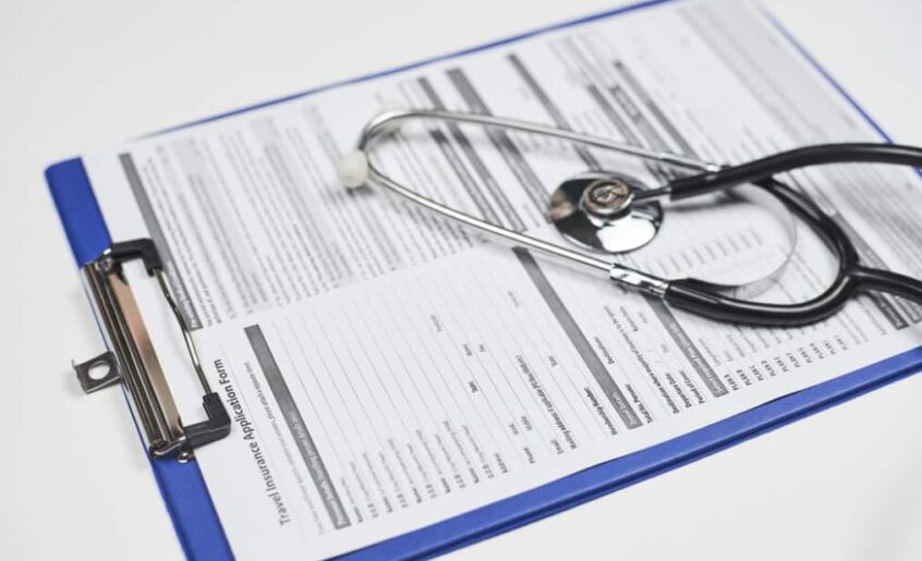 A clipboard with a medical report and a stethoscope on top